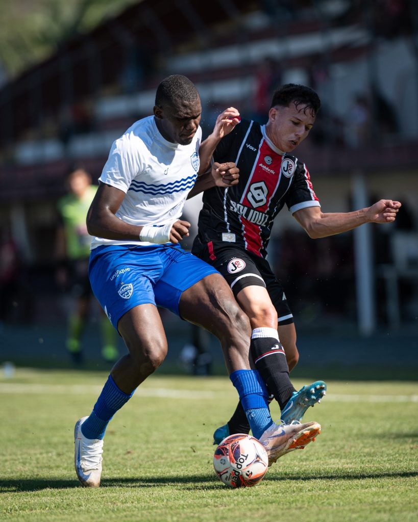 Jogador do Joinville disputa a bola com um atleta do Barra